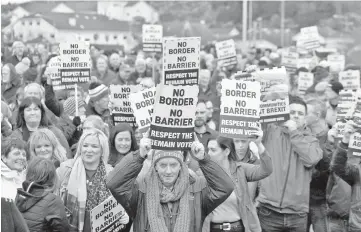  ??  ?? People attend a protest against Brexit at the border crossing between the Republic of Ireland and Northern Ireland in Carrickcar­non, Ireland. — Reuters photo