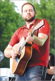  ?? Westside Eagle Observer/MIKE ECKELS ?? Nashville sensation Blane Howard plays a guitar riff during the 68th Decatur Barbecue concert on the Bill Montgomery USO Bandstand at Veterans Park in Decatur Aug. 6. Howard was the featured singer at this year’s event.