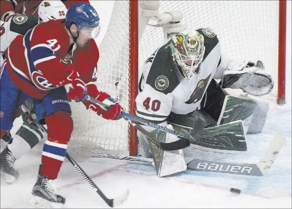  ?? GRAHAM HUGHES/THE CANADIAN PRESS ?? Wild goaltender Devan Dubnyk makes a stick save against Canadiens center Paul Byron during Minnesota’s 4-2 win Thursday at Montreal. The Wild have won 10 consecutiv­e games.