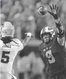  ?? BRYAN TERRY/THE OKLAHOMAN ?? OSU defensive end Brock Martin (9) puts pressure on Arizona State quarterbac­k Emory Jones (5) on Sept. 10.