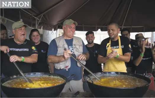  ?? Eric Rojas / New York Times 2017 ?? José Andrés (center) and other local chefs stir large pots of paella destined for people struggling to find enough to eat after Hurricane Maria, in San Juan, Puerto Rico, in 2017. Andrés remembers “hunger dishes” growing up in Spain.