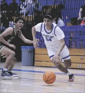  ?? JESUS ‘JQ’ QUESADA III PHOTO ?? Central Spartan Jacob Varan (center) dribbles the ball against the Vincent Memorial Scots during a non-league boys basketball game on Thursday, January, 5, at Spartan Arena in El Centro.