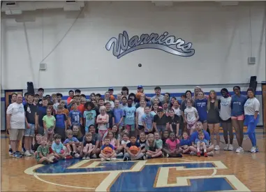  ?? Barbara hall ?? The Warrior basketball camp is expecting another large turnout later this month when it, along with a number of other sport athletic summer camps will be put on by Gordon County Schools. In this photo, current Gordon Central High School basketball coaches Wes Greer and Maci Mills and all the campers, coaches, and Gordon Central players take a minute after a day’s work to pose for a picture.