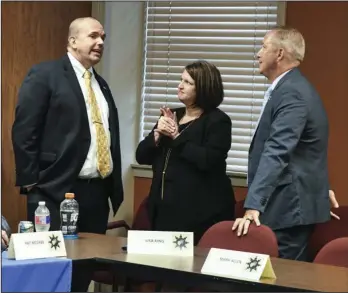  ?? The Sentinel-Record/Grace Brown ?? TARGETING CRIMINALS: Duane “Dak” Kees, left, U.S. attorney for the Western District, chats with Garland County Prosecutin­g Attorney Michelle Lawrence and Bryan Achorn, assistant U.S. attorney, during a break in a more than two-hour meeting Wednesday night of public officials and community leaders to discuss the increase in violence in Hot Springs.