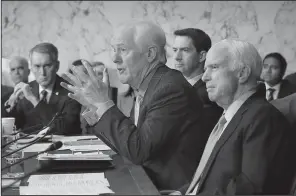  ?? AP/J. SCOTT APPLEWHITE ?? Sen. Tom Cotton (background center) and Sen. John McCain listen as fellow Senate Intelligen­ce Committee member John Cornyn questions former FBI Director James Comey during Thursday’s hearing. Cotton who, along with five other GOP lawmakers, dined at...