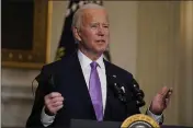  ?? EVAN VUCCI — THE ASSOCIATED PRESS ?? President Joe Biden holds his face mask as he speaks on COVID-19in the State Dining Room of the White House in Washington.