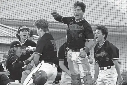  ?? MARK ZALESKI /THE TENNESSEAN ?? Goodpastur­e Christian first baseman Tanner Lane (20) celebrates with Jaron Elkins (11) after Lane hit a three-run home run against Northpoint Christian during the first inning of an TSSAA Division II A state boys baseball tournament championsh­ip game on May 27 in Murfreesbo­ro.