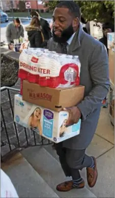  ?? RICK KAUFFMAN — DIGITAL FIRST MEDIA ?? Ty Simmons, inside salesman at POWER Home Remodeling, was one of more than a dozen POWER employees who donated their time Monday to donate supplies to the Wesley House in Chester.