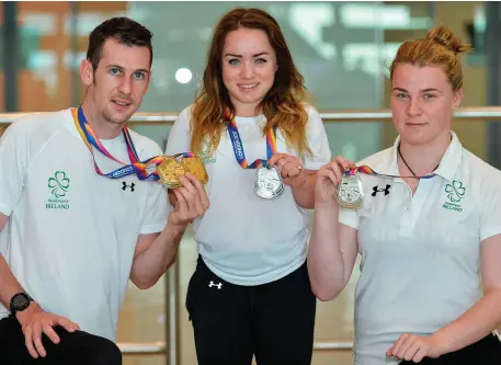 ??  ?? Team Ireland athletes Michael McKillop, who won gold in both the T38 800m and T37 1500m, Niamh McCarthy, who won silver in the F41 Discus, and Noelle Lenihan, who won silver in the F38 Discus, arrive home to Dublin Airport. Photo: Sam Barnes/Sportsfile