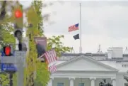  ?? AP PHOTO/SUSAN WALSH ?? The American flag flies at half-staff over the White House in Washington on Friday.