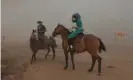  ??  ?? Horse riders surrounded by smoke from the Richard Spring fire as it moves toward Ashland, Montana. Photograph: Mike Clark/