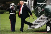  ?? AP/JACQUELYN MARTIN ?? President Donald Trump steps off Marine One with a salute Thursday as he arrives at the White House after his trip to New York for the U.N. General Assembly. After watching Brett Kavanaugh’s testimony Thursday, Trump tweeted that Kavanaugh “showed America exactly why I nominated him.”