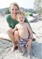  ??  ?? Claire Tweedie introduces son Toby to beach life.