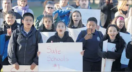  ?? Luis Sinco Los Angeles Times ?? TEACHERS, STUDENTS and parents gather for a pro-school-police rally at Mulholland Middle School in Lake Balboa on Friday.