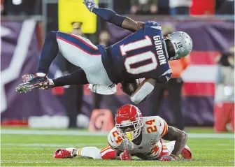  ?? STAFF PHOTO BY MATT STONE ?? SIDEWAYS: Patriots receiver Josh Gordon gets upended by Kansas City’s Jordan Lucas during the first quarter of last night’s game in Foxboro.