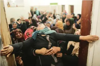  ??  ?? A relative of Hamdan Abu Amsha, who was killed a day earlier by Israeli forces, cries during his funeral in Beit Hanun, Gaza Strip, on Saturday. (AFP)