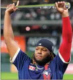  ??  ?? The Associated Press
Vladimir Guerrero Jr. of the Toronto Blue Jays holds the MVP trophy after the MLB All-Star game, Tuesday, in Denver.