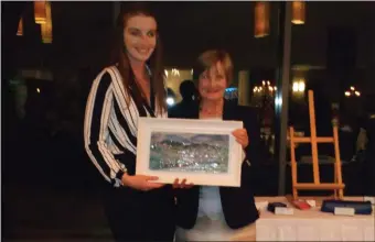  ??  ?? Maeve Kelly being presented with her winning prize by Lady Captain Bridie Henry at the joint Captains Day in Castle Dargan. Ladies and Gents enjoyed a great golfing day followed by dinner and prize giving. Ladies results as follows: 1st prize was won by Maeve Kelly, 2nd prize by Anita Carty, 3rd prize by Christina Fowley and 4th prize went to Joan Scanlon.