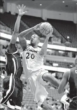  ?? Allen J. Schaben Los Angeles Times ?? LONG BEACH STATE’S T.J. Robinson goes to the basket against UC Davis’ J.T. Adenrele during the first half of 49ers’ easy victory Thursday at Honda Center.