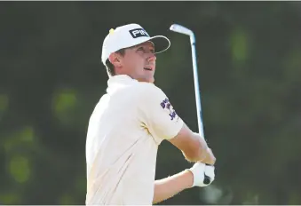  ?? MATT SULLIVAN/GETTY IMAGES ?? Canadian Mackenzie Hughes watches his tee shot on the 15th hole during Sunday’s final round of the Honda Classic at PGA National Resort and Spa Champion in Palm Beach Gardens, Florida.