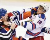  ?? CP PHOTO ?? New York Rangers player Marc Staal, right, and Edmonton Oilers player Matt Hendricks trade blows during the second period of the NHL game in Edmonton on Friday.