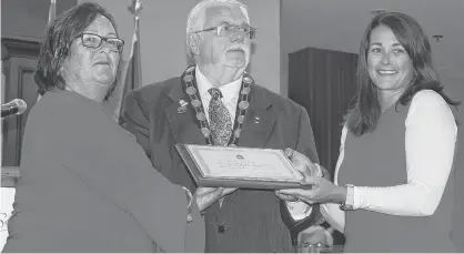  ?? BRAE SHEA/JOURNAL PIONEER ?? Barbara McNeill, left, accepts an award from Summerside Mayor Basil Stewart and Coun. Carrie Adams at the celebratio­n held to mark the 30th anniversar­y of her successful swim of the English Channel.