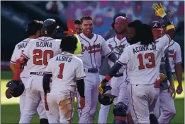  ?? JOHN BAZEMORE — THE ASSOCIATED PRESS ?? Atlanta Braves Freddie Freeman celebrates driving in the game-winning run against the Cincinnati Reds in the 13th inning during Game 1 of a National League wild-card series Wednesday in Atlanta. The Atlanta Braves won 1-0.