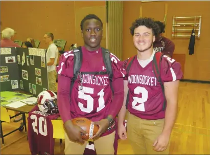  ?? Joseph B. Nadeau/The Call ?? Mouhamed Seck, left, a senior and captain of the Woonsocket High School varsity football squad, stands with Logan Coles, a freshman prospect.