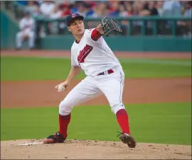  ??  ?? Cleveland Indians Trevor Bauer delivers to Oakland A’s Jed Lowrie in Cleveland, Friday.