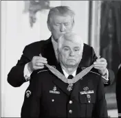  ?? ASSOCIATED PRESS ?? PRESIDENT DONALD TRUMP bestows the nation’s highest military honor, the Medal of Honor, to retired Army medic James McCloughan during a ceremony in the East Room of the White House on Monday in Washington. McCloughan is credited with saving the lives of members of his platoon nearly 50 years ago in the Battle of Nui Yon Hill in Vietnam.