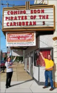  ?? DIGITAL FIRST MEDIA FILE PHOTO ?? The State Theatre of Boyertown began showing films again in May 2017, following a two-year hiatus. In this file photo are State Theatre Manager Shannon Anthony, left, and Vice President Jake Zimmers beneath the State Theatre’s marquee announcing the first movie to be presented with the theater’s newly acquired digital projector.