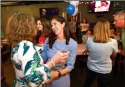  ?? NWA Democrat-Gazette/ANDY SHUPE ?? Nicole Clowney, Democratic candidate for State House District 86, gets a hug Tuesday from volunteer Nancy Firman of Fayettevil­le after early voting results were announced during a watch party at U.S. Pizza in Fayettevil­le.