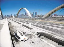  ?? Myung J. Chun Los Angeles Times ?? DEBRIS FROM a takeover crash remains on the 6th Street Viaduct on Tuesday. Cameras will be added to the bridge to deter and identify drag racers.