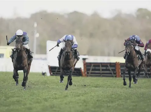  ??  ?? 0 Aidan Coleman and Paisley Park, right, go into overdrive after clearing the last to win the Long Walk Hurdle from Thyme Hill, far left.