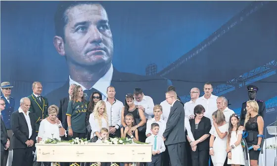  ??  ?? Family members pay their last respects at the coffin of Joost van der Westhuizen during his memorial service.