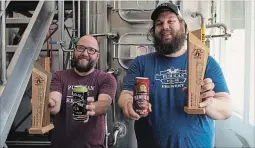  ?? JESSICA NYZNIK EXAMINER ?? Publican House Brewery’s assistant brewer Derek Murray, left, and Kevin Buckle, head brewer, celebrate two wins at the 2018 Canadian Brewing Awards.