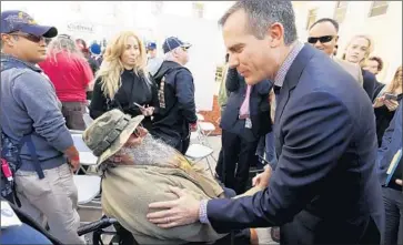  ?? Al Seib
Los Angeles Times ?? MAYOR ERIC GARCETTI talks with homeless Vietnam veteran Lone Wolf during a stand-down at the West Los Angeles Veterans Affairs campus, where a group of veterans received housing vouchers.