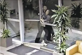  ??  ?? An image from a security video shows an assailant grabbing Paneez Kosarian as she enters her condominiu­m building Sunday. The alleged attacker’s release from custody has been criticized.