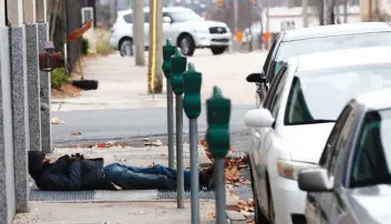  ?? Associated Press ?? A homeless man takes advantage of the warm air coming from a sidewalk vent to stay warm Wednesday in downtown Jackson, Miss. The weather forecast for the deep South calls for dangerousl­y cold temperatur­es.