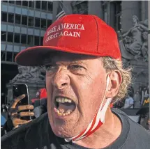  ??  ?? A vociferous Trump supporter at a New York rally.