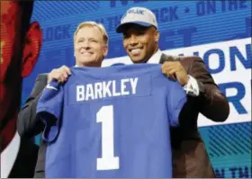  ?? DAVID J. PHILLIP — THE ASSOCIATED PRESS ?? Penn State running back Saquon Barkley, right, poses with Commission­er Roger Goodell after being selected with the No. 2 overall pick by the New York Giants during the first round of the NFL Draft Thursday.