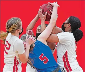  ?? SEAN D. ELLIOT/THE DAY ?? NFA guards Sarah Ericson (22), Jenissa Varela, back, and Cynthia Deneus, right, keep Waterford guard Olivia Davidson from a rebound in the ECC South Division girls’ basketball tournament final on Thursday night in Norwich. NFA won 57-33.