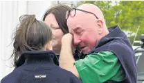  ??  ?? Care . . . Lake Ohau resident Hugh Spiers is comforted after visiting the village where his bed and breakfast was destroyed in the blaze.