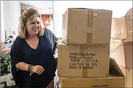  ?? BEN GRAY / AP ?? Ginger Pigg moves boxes of shopping bags in the storage room of her gift boutique The Perfect Pigg in Cumming, Ga. on Thursday. The bags should have been delivered in four weeks, but took 14 weeks.