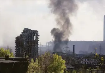  ?? Alexei Alexandrov / Associated Press ?? Smoke rises from the Azovstal steel mill in Mariupol. About 2,000 Ukrainian fighters and a few hundred civilians are holed up in the tunnels and bunkers under the sprawling steelworks.