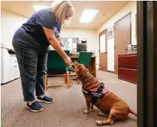  ?? ?? Church office manager Jill Waldrop gives Hannah a treat.