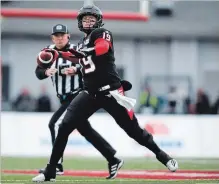  ?? JEFF MCINTOSH THE ASSOCIATED PRESS ?? Stampeders quarterbac­k Bo Levi Mitchell prepares to throw the ball during first-half CFL West Division final action against the Winnipeg Blue Bombers in Calgary on Sunday.