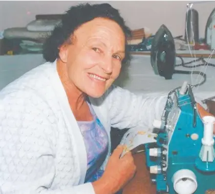  ?? Photo / Supplied ?? Amy Bourke working on garment alteration­s while she worked at Bon Marche in Hastings.