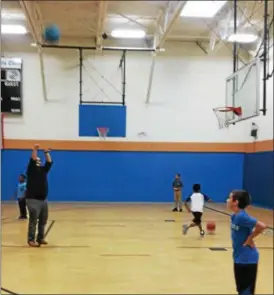  ?? PAMELA REESE FINCH — FOR THE RECORD ?? Troy Boys and Girls Club Executive Director Patrick Doyle shoots hoops with some of the club’s younger members. Doyle joined the club as a 5- year- old and has worked his way up over the past three decades to become its leader.