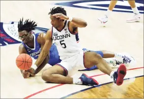  ?? David Butler II / Pool Photo via AP ?? Creighton’s Denzel Mahoney, left, and UConn’s Isaiah Whaley battle for the ball in the second half on Sunday.